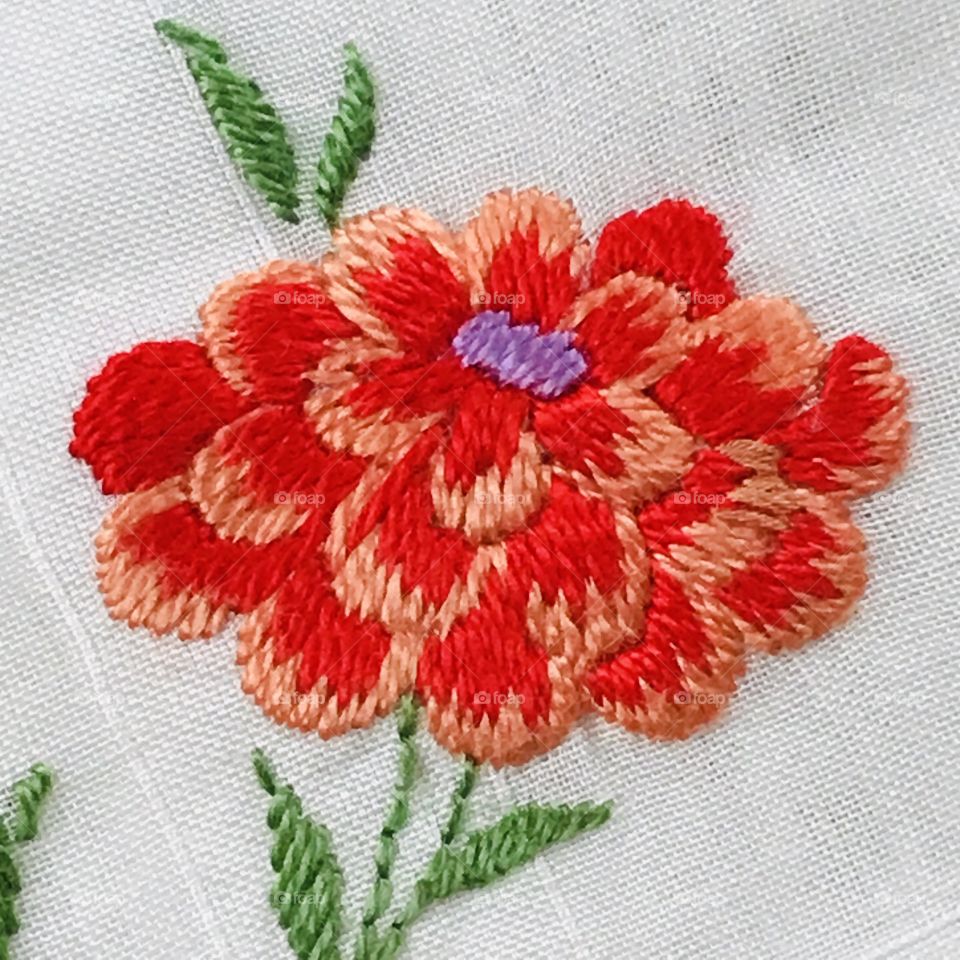 Large single bright orange hand embroidery embroidered flower floral design with white background