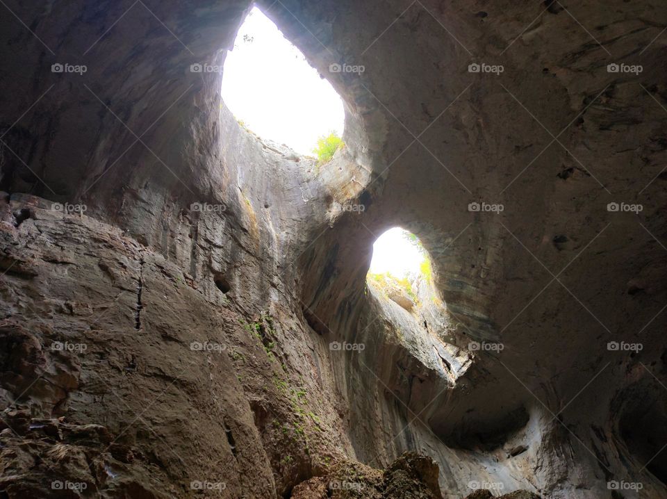 God's eyes cave in Bulgaria / Cave exploring / beautiful nature in Bulgaria / seeing the sky through holes in an enormous cave