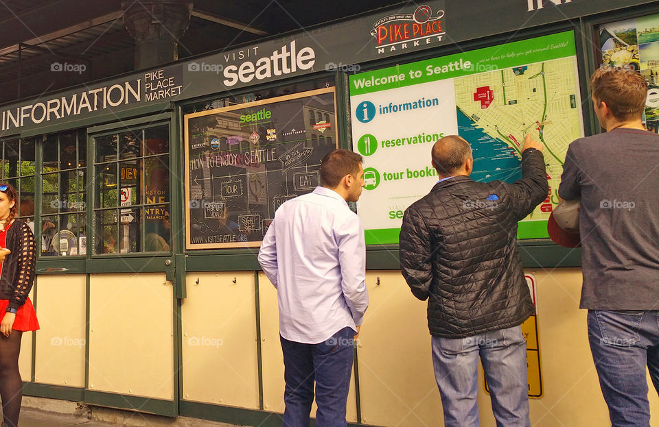Men Looking at the Information Board at Pike Place Market in Seattle Washington