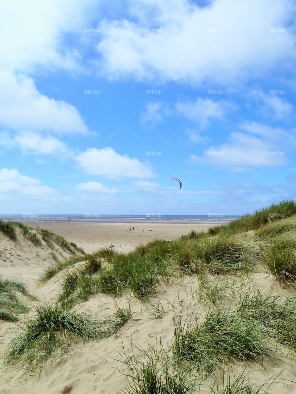 Beach against cloudy sky