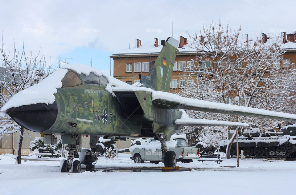 Military aircraft covered with snow