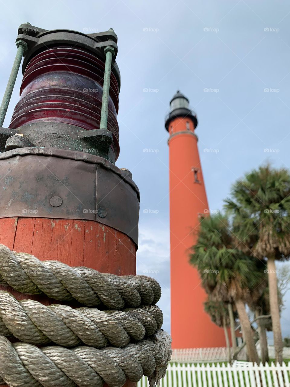 Ponce Inlet Lighthouse, also called the Mosquito Inlet Lighthouse, with marine style light pole with ropes on the foreground. The current tower was lit in 1887 and stands 175 feet tall, making it the tallest lighthouse in Florida, third in the USA.