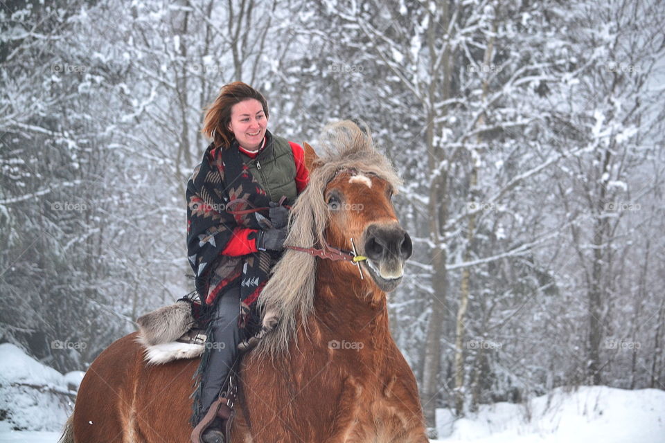 Young woman sitting on horse