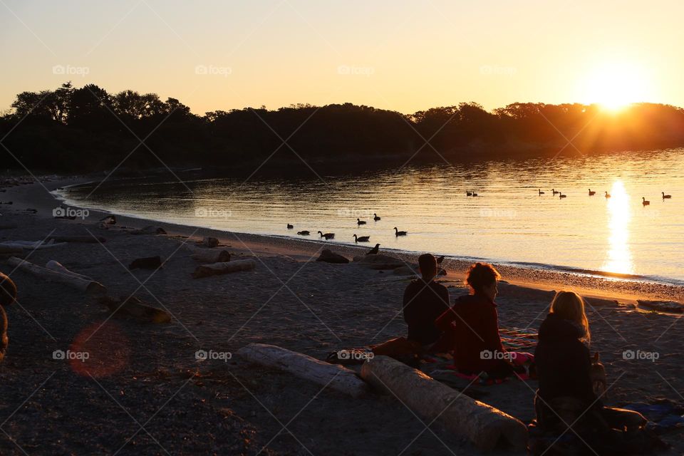 People meditating on sunrise 