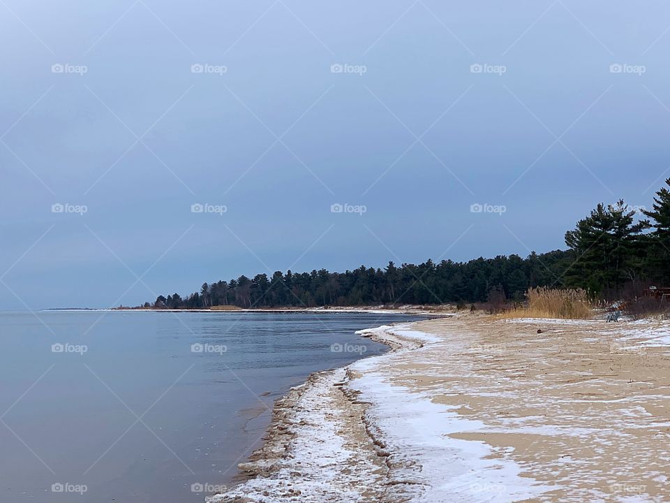 Snowy beach scene on the Lake Huron shoreline in Sanborn Township near Alpena, Michigan. 