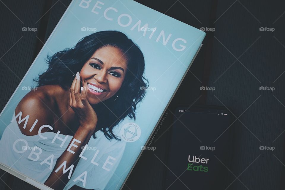 Michelle Obama Becoming Book and UBER eats, relaxing at home, staying home in quarantine, corona virus quarantine, reading and eating, reading a book, Michelle Obama, UBER Eats, advertising, enjoying the outdoors with books and food