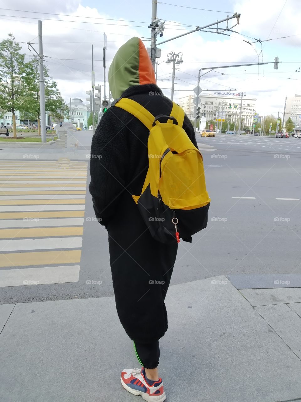 A young man at a pedestrian crossing.
