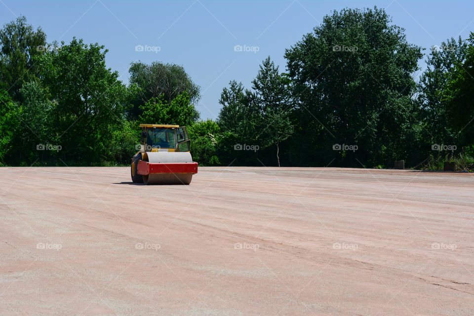 Leveling machine on site. Construction site in Serbia full of sand