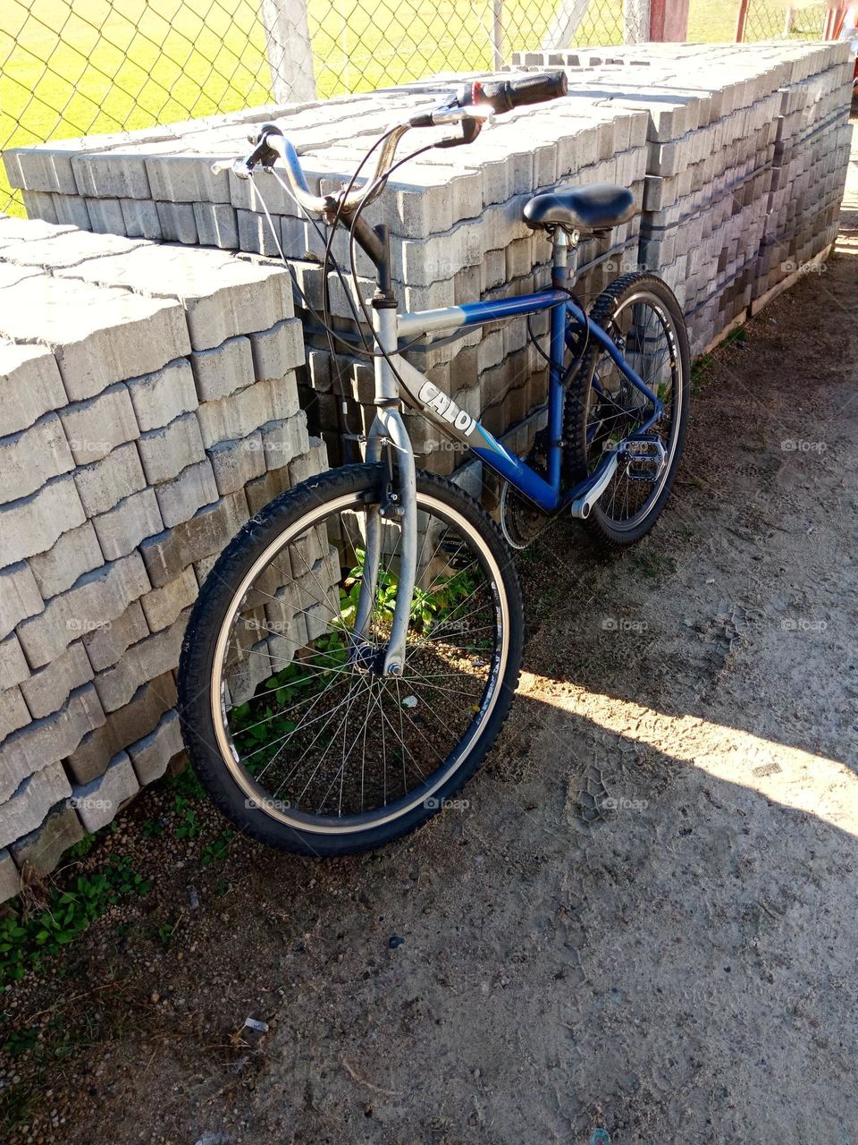 A bycicle by a pile of concrete blocks