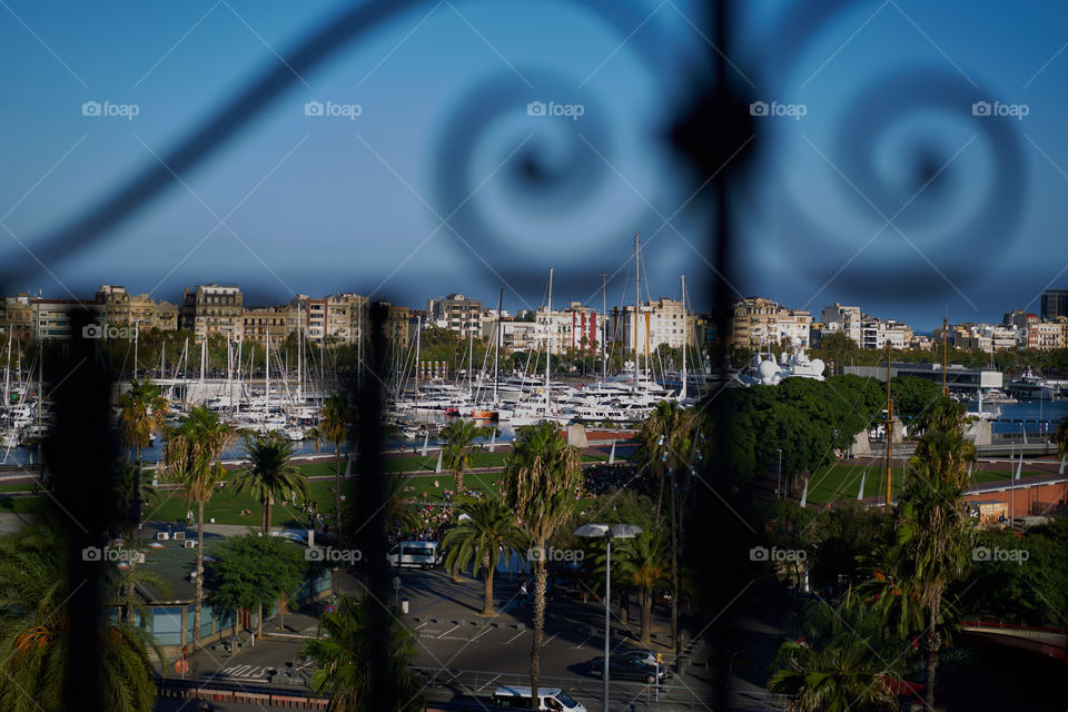 Barcelona's harbor through a fence