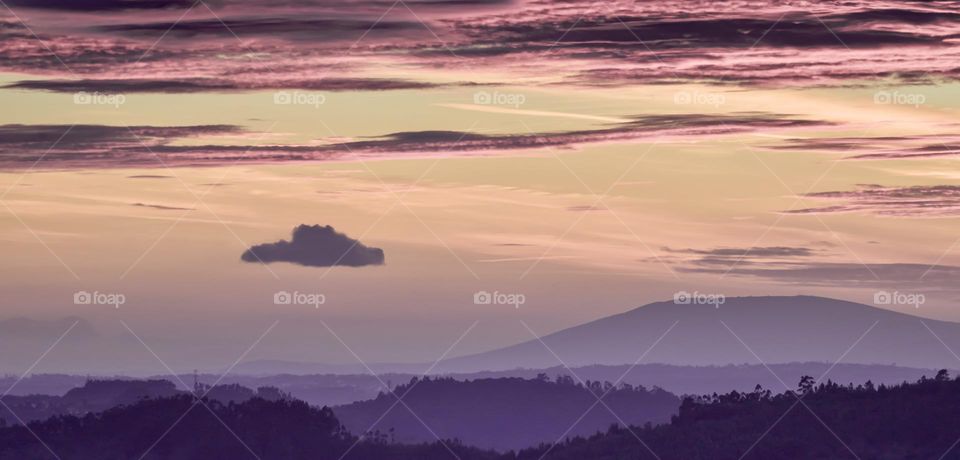 A dusky purple, winter evening sky, silhouetting hills and mountains across Santarém, Portugal