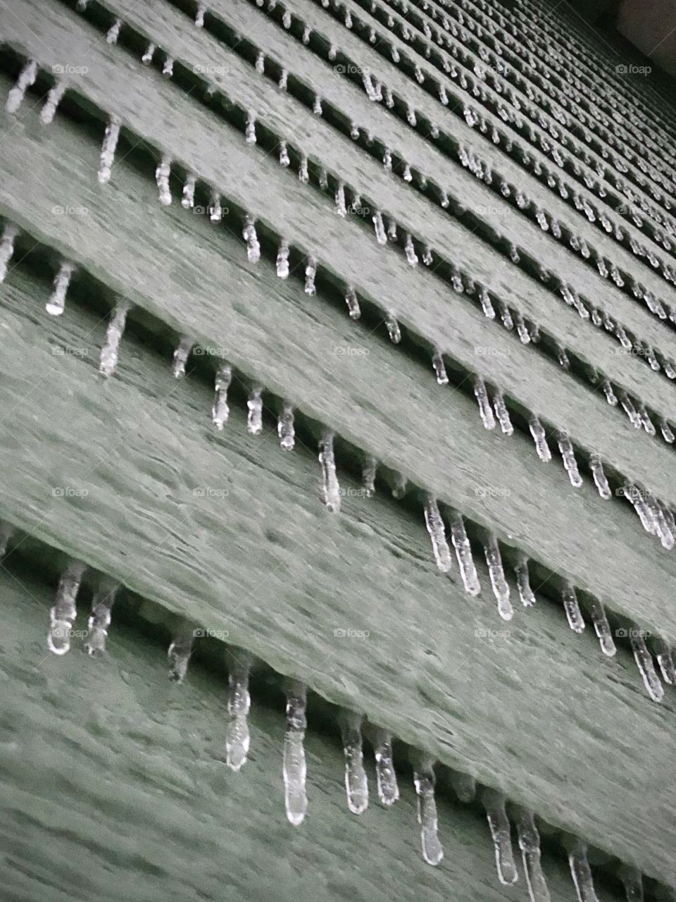 Ice encapsulates the walls of a house in the cold of winter.