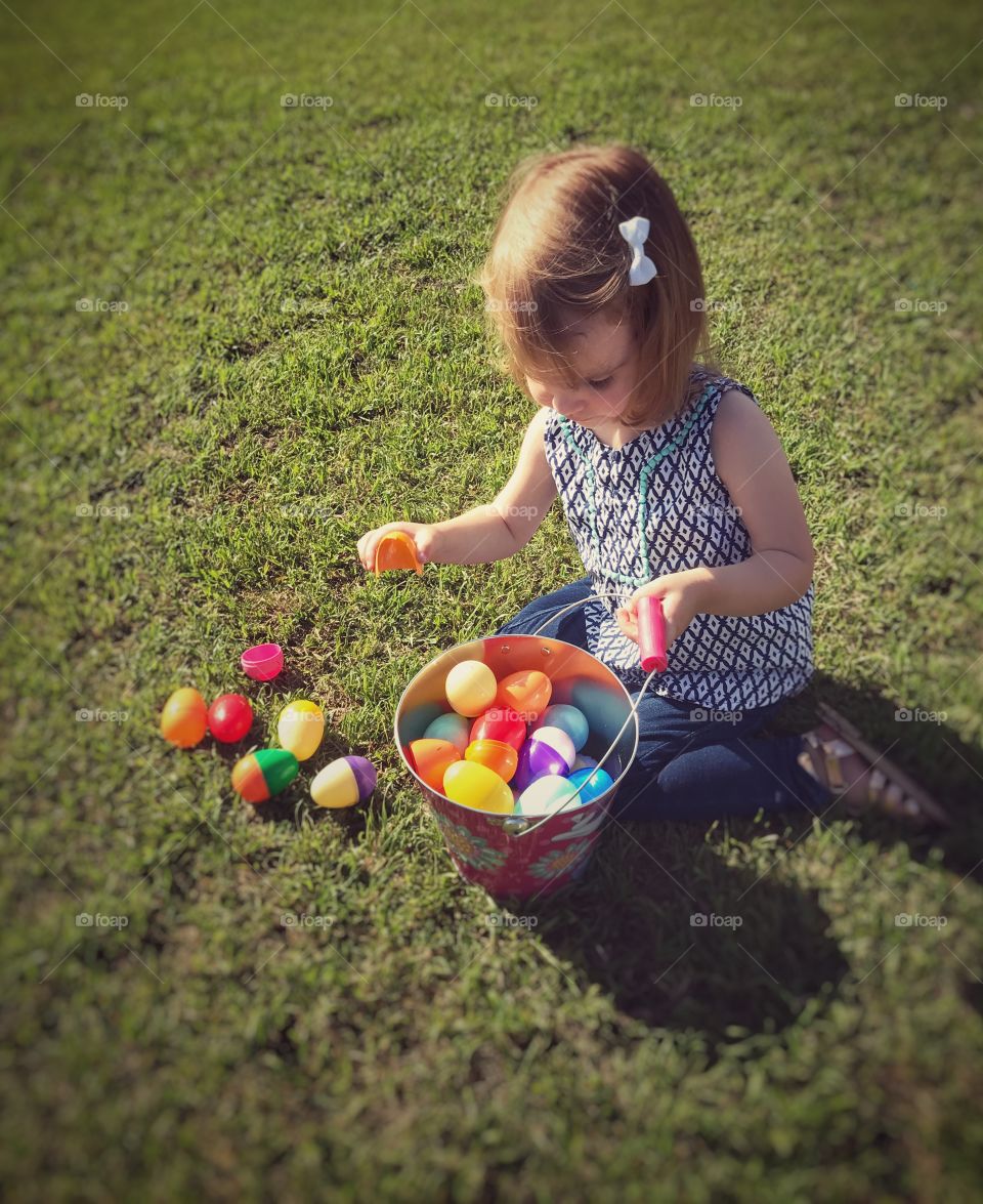Little girl doing an Easter egg hunt
