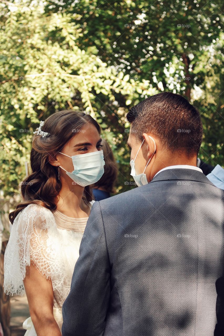 The bride and groom are happily waiting in line for marriage registration