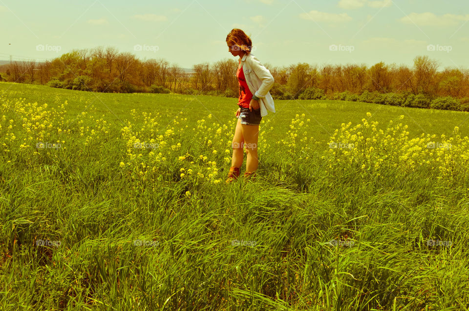 Woman standing in a field of flowers