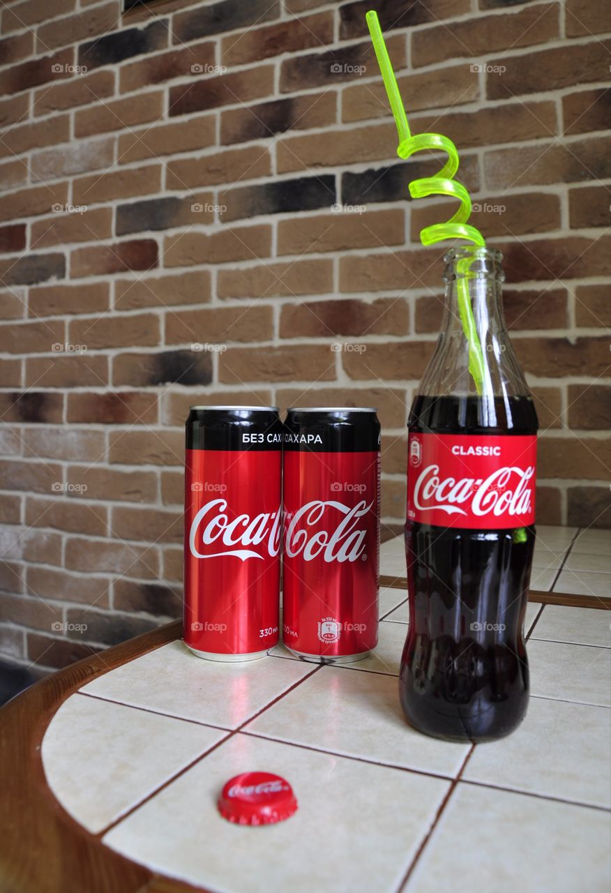 Two cans and one bottle of Coca-Cola