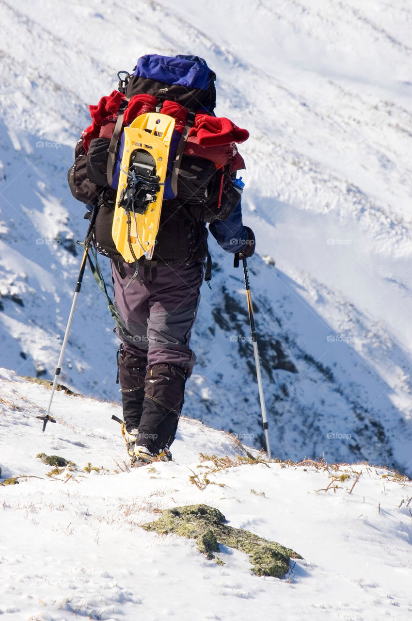 Backpacker peers into the valley on Mount Adams in the presidential