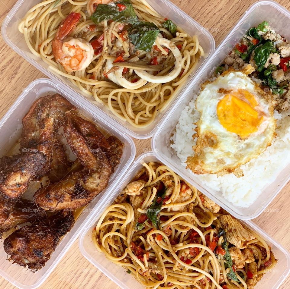 Spicy Thai western fusion meal with noodles , rice and chicken wings 