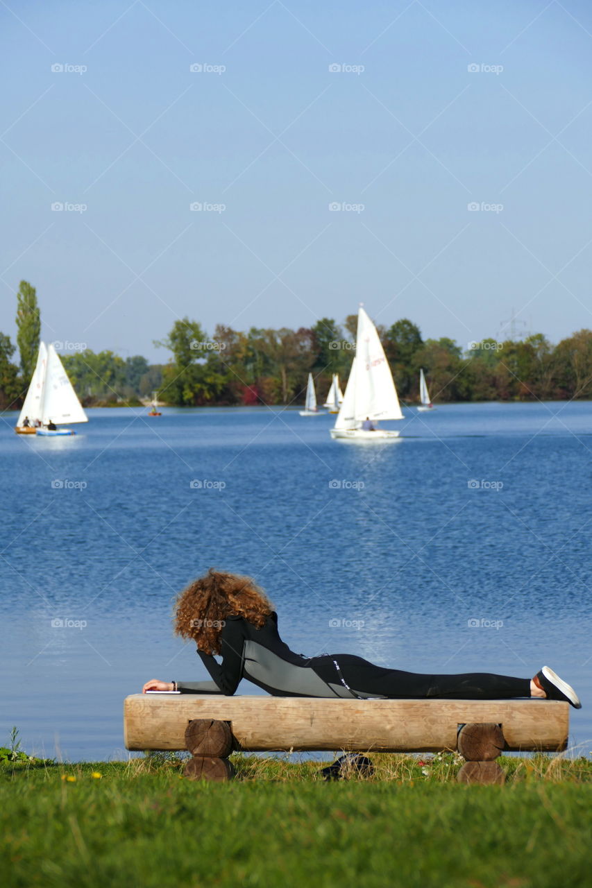 woman on a bench at the lake