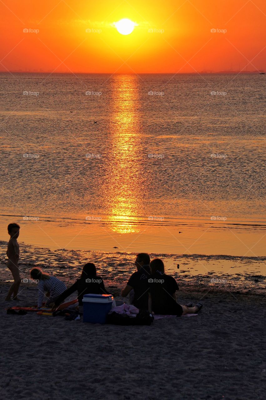 Family picnic in the sunset