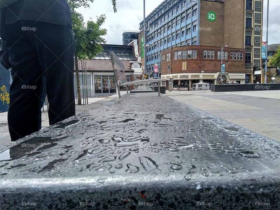 water droplets on a slab next to some chairs