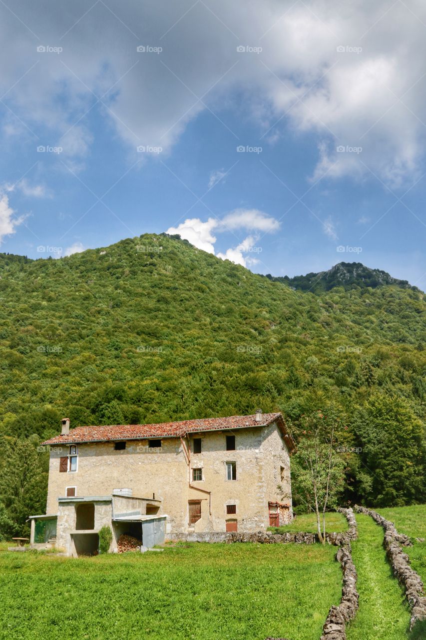 Old farm in a mountain valley, summer time 