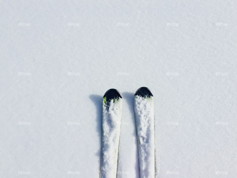 Minimalistic view of skis on fresh snow