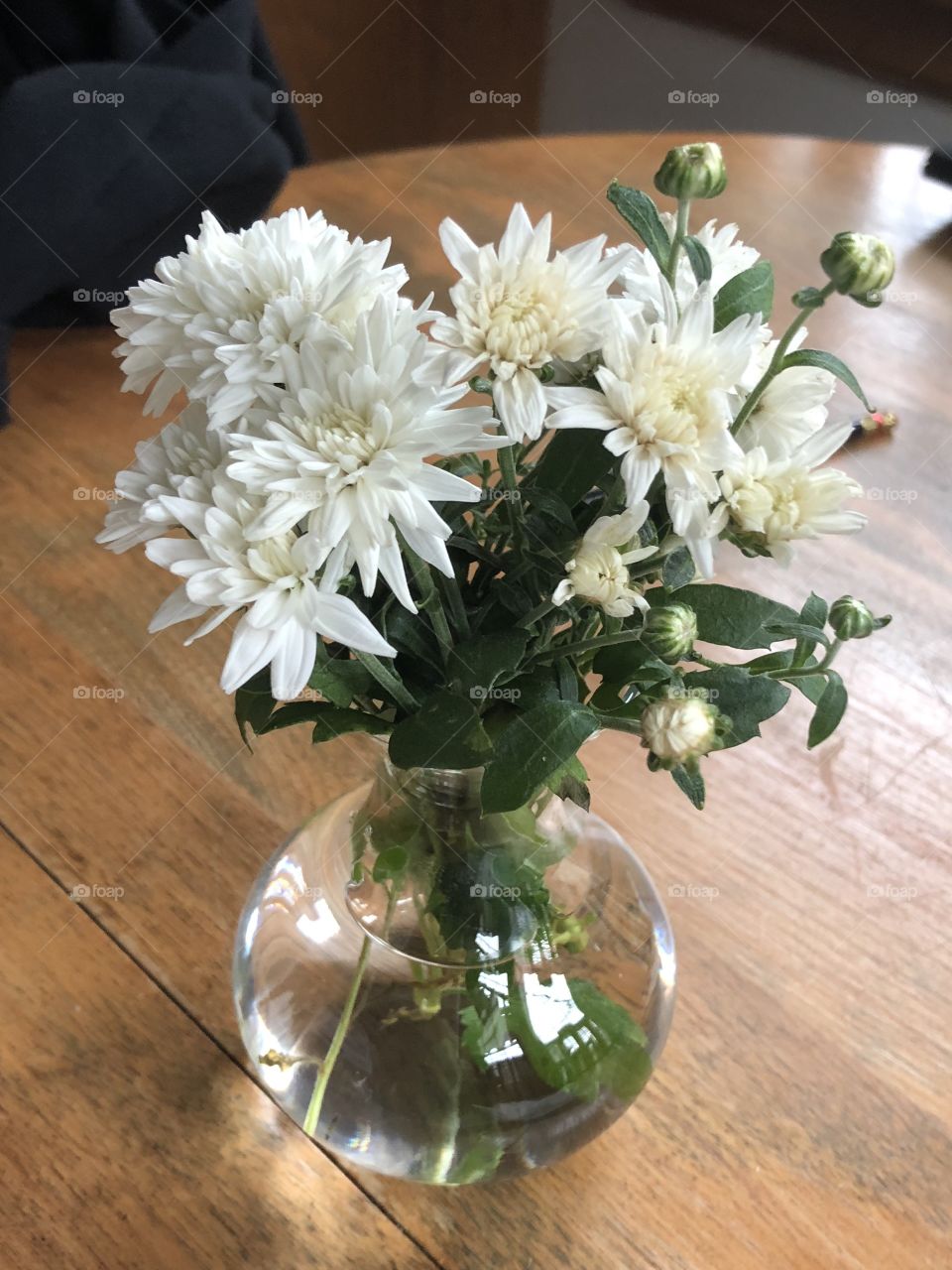 Mums with glass-ball vase