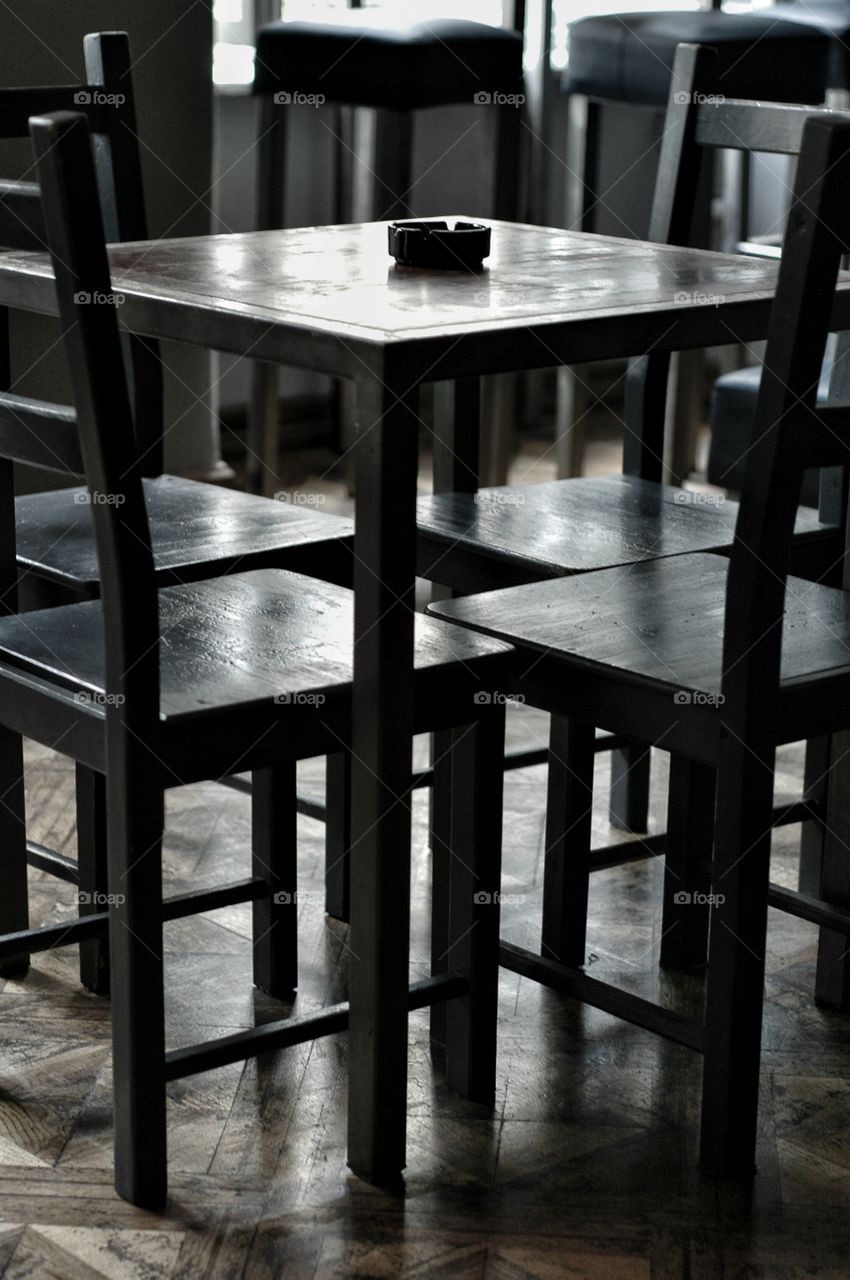 Cafe table and chairs. Cafe table and chairs standing on the wooden floor