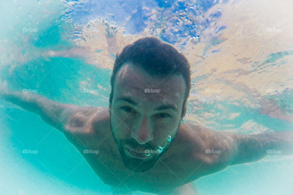 Man swimming under water in sea
