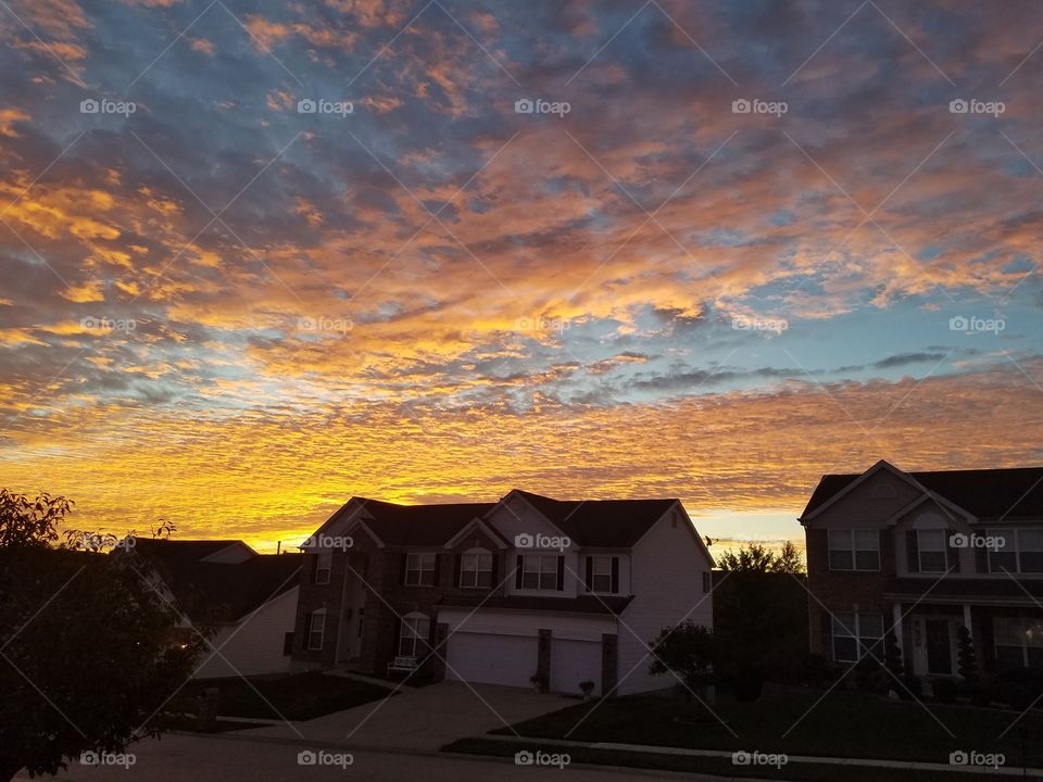 Beautiful sunrise outside my front door. The sunlight hit the clouds in just the right way to leave this orange kissed sky!