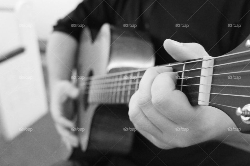 Close-up of a person playing guitar