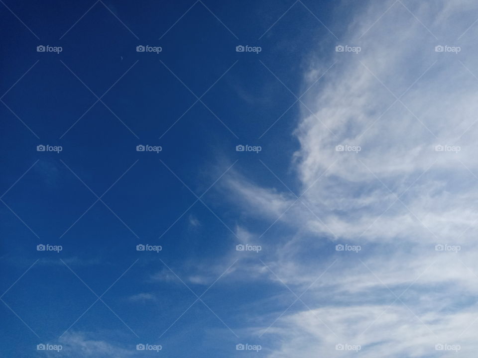 Blue sky versus white cloud trying to merge