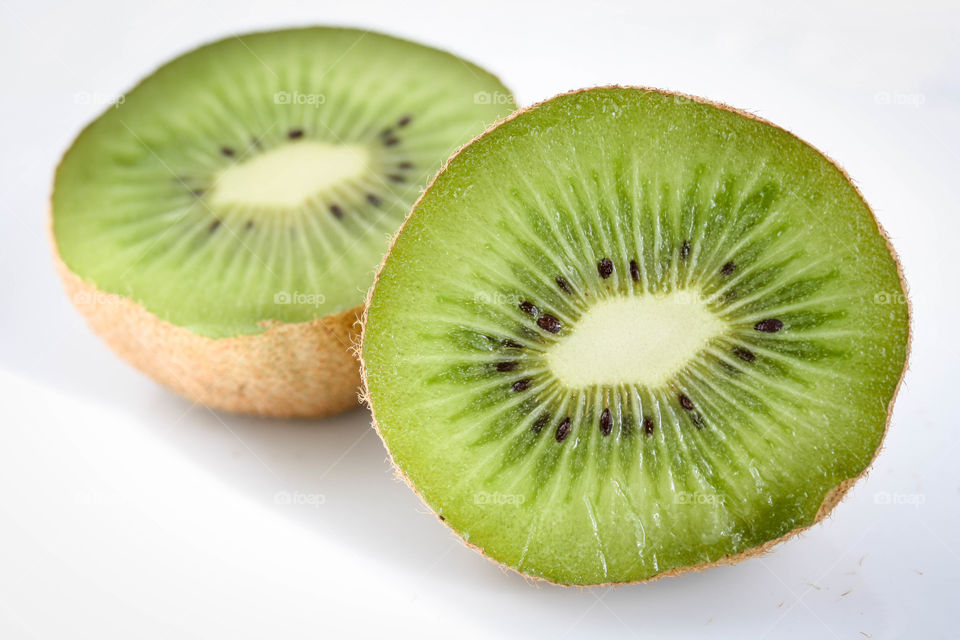 Halves of kiwi fruit isolated on white background