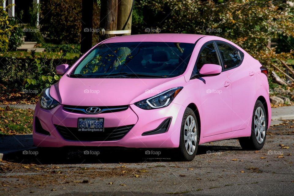 Pink Hyundai car parked on the street