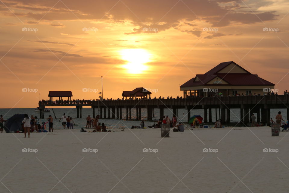 Sunset by the pier on the beach 