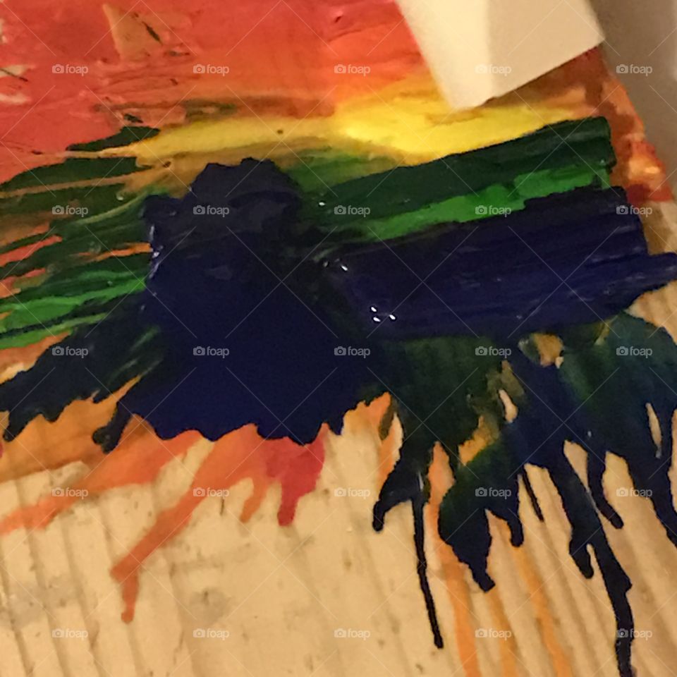 Use a hair dryer to melt crayons and splatter the colors to create an abstract art painting.