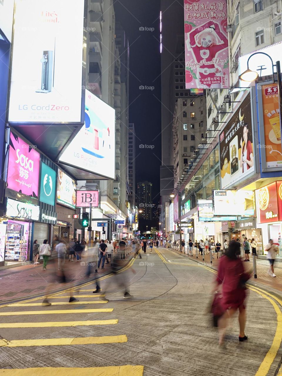 People crossing the street at night