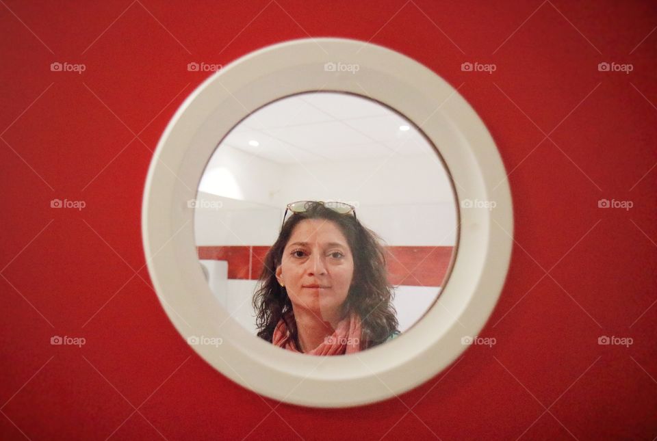 Woman looking trough circle window