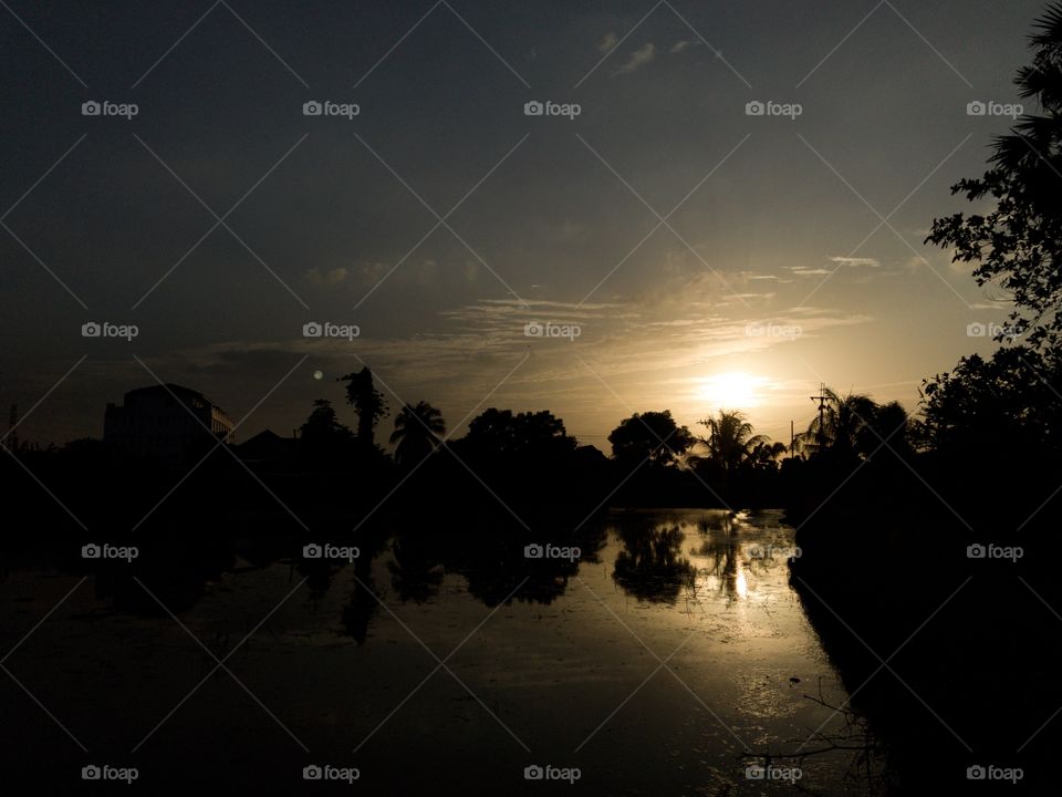 Sunset view with silhouette and water reflection 