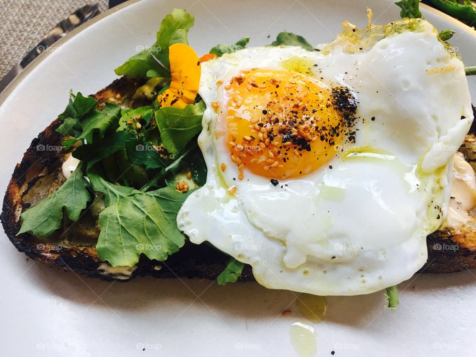 Fresh avocado toast with fried egg