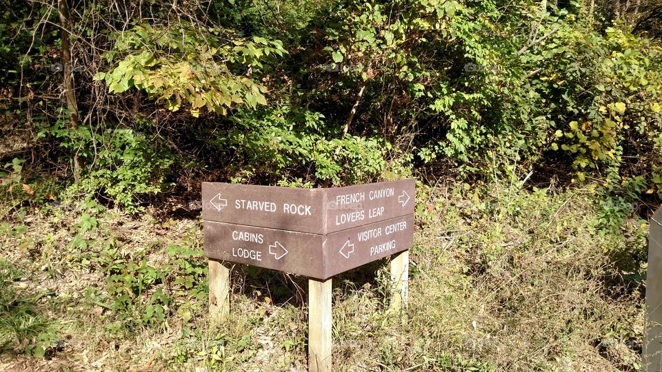 signs at the state park giving directions to the different hiking areas