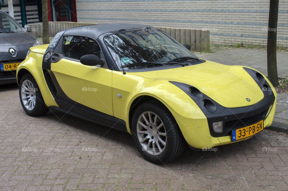 A Yellow Smart Car At Amsterdam The Netherlands 20-5-2024