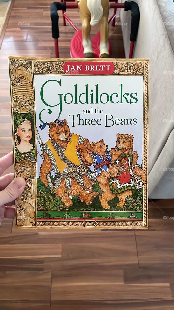 Jan Brett illustrated book, woman holding Jan Brett book, Goldilocks and the three Bears classic book, Jan Brett illustrates a classic story