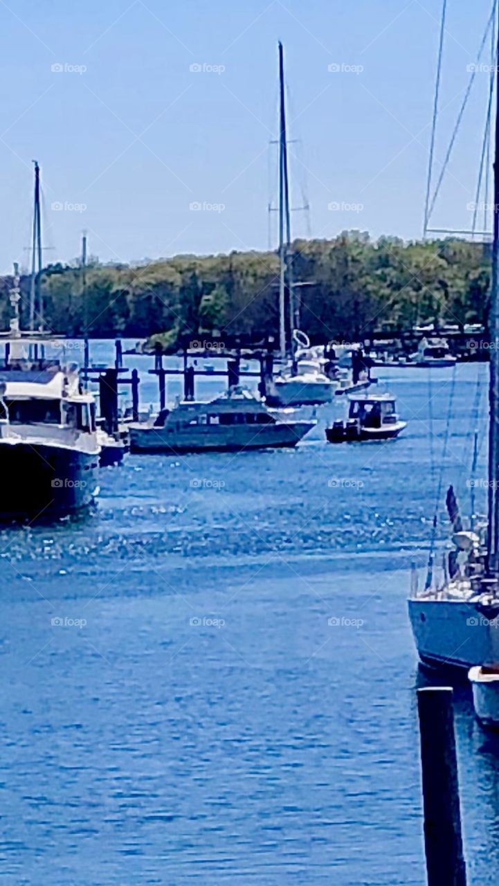 Boats at the marina of New Rochelle photographed on a bright sunny afternoon in the summer of 2021. Hypnotic Productions