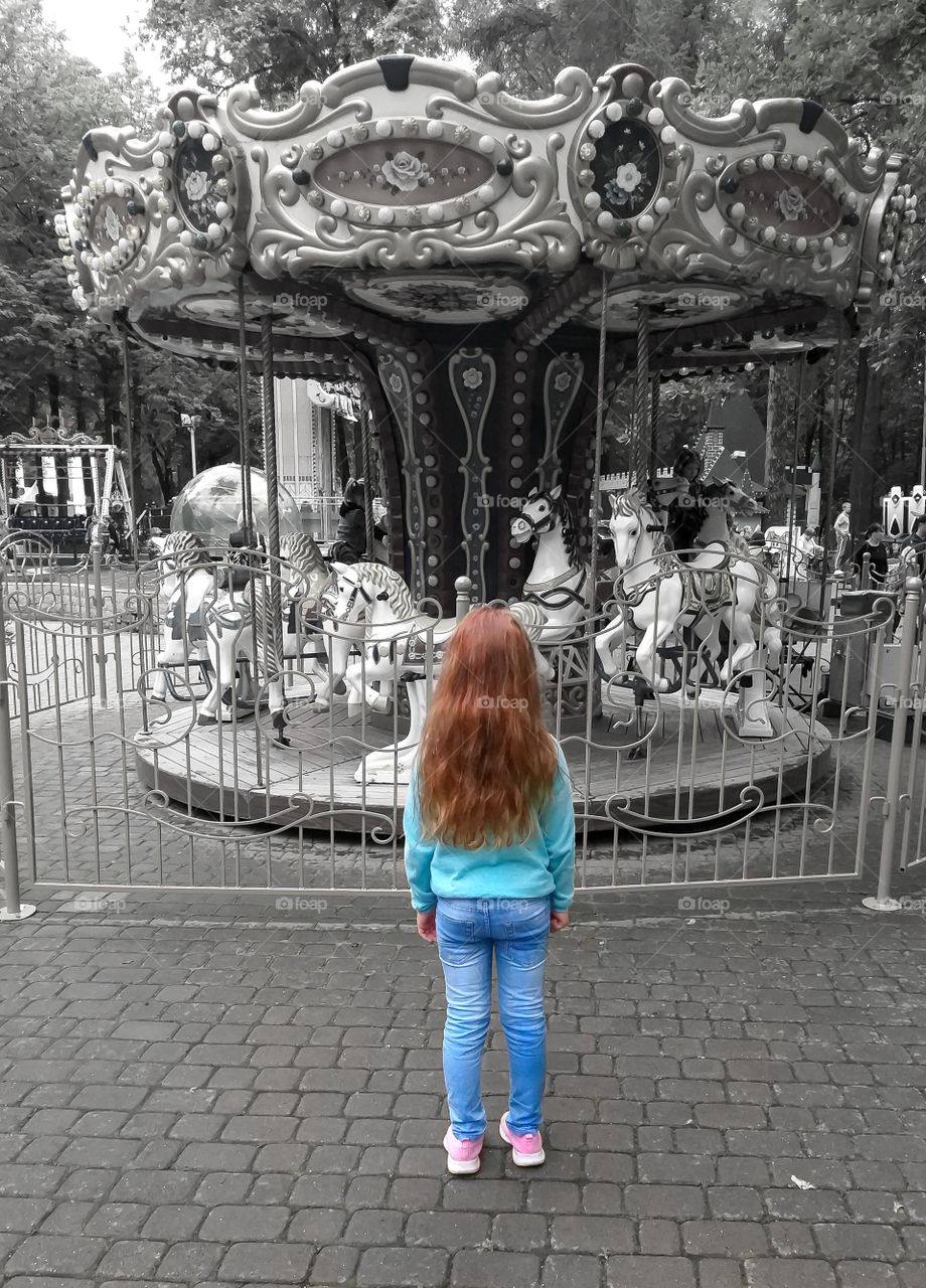 girl and carousel with horses