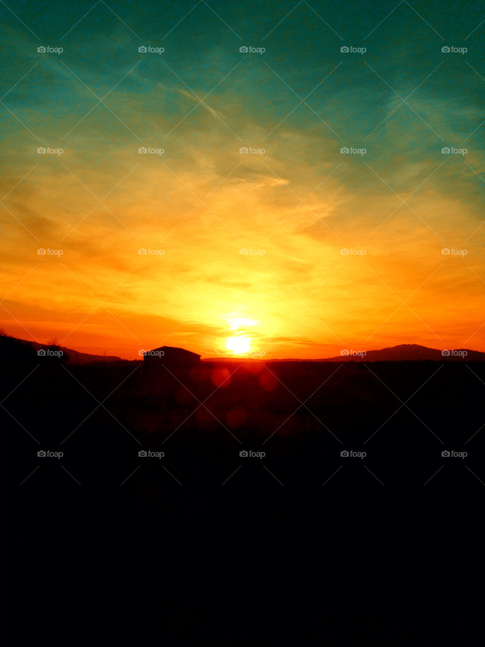 Lonely house in front of an amazing sunset