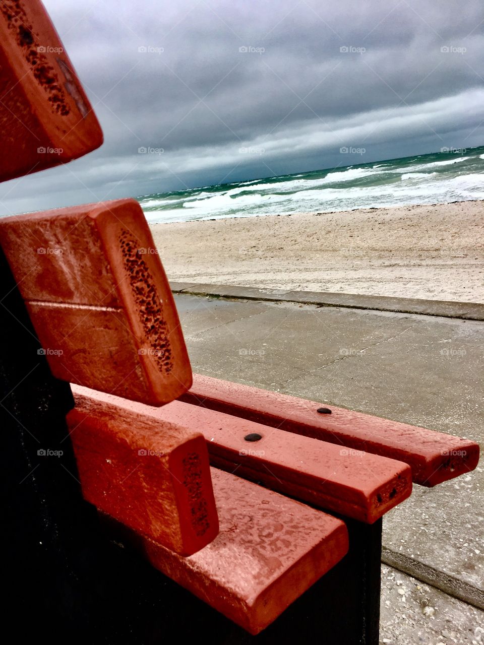 Red bench at the beach