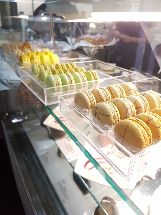 Lineup of macaroons in a glass counter