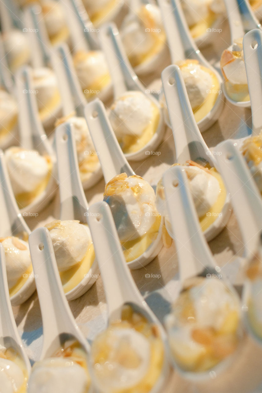 Individual desserts served on ceramic spoons